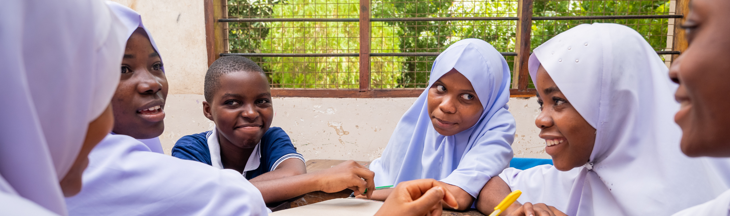 Girls education in Africa adolescents talking over a class assignment