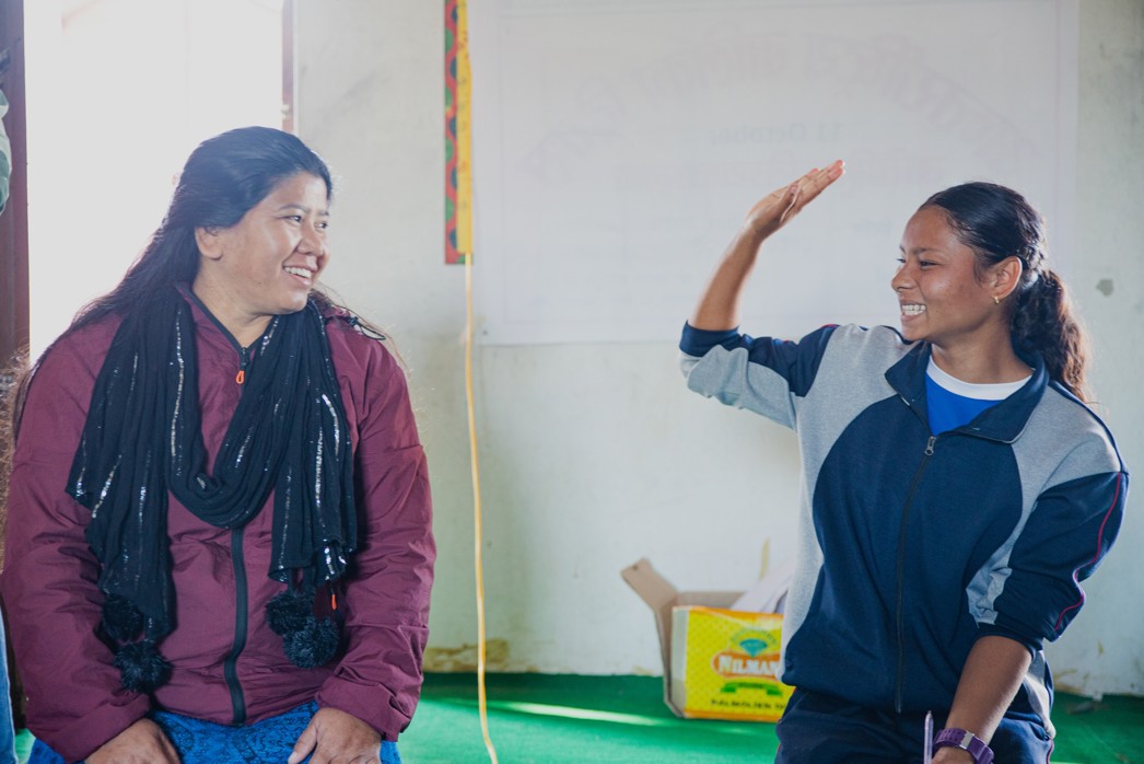 Empowering girls, parents participating in a Room to Read mentoring session