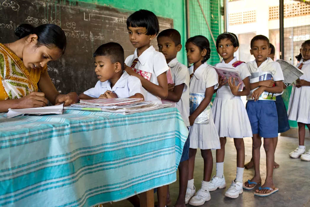 Children checking out books in Sri Lanka | Room to Read. Photo credit: Anne Holmes