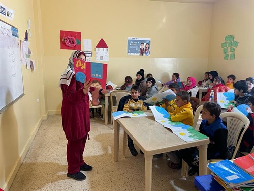 Lebanon instructor reading to a classroom.