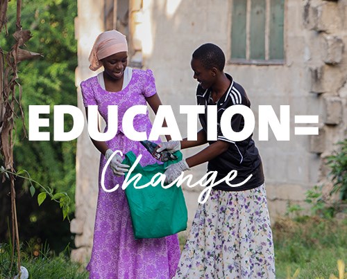 Two girls outside holding bag together with text "Education = Change"