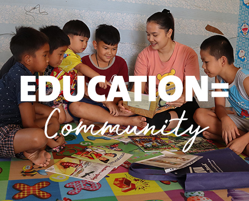 Students sitting in a circle with book and text "Education = Community"