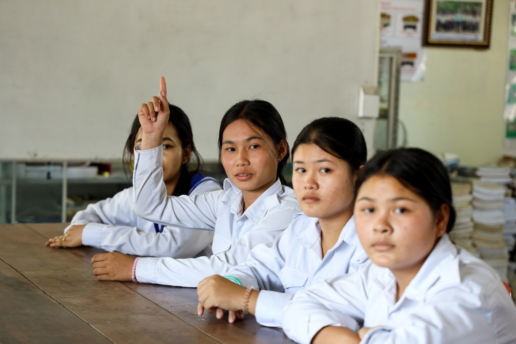 Girls participating in a classroom discussion