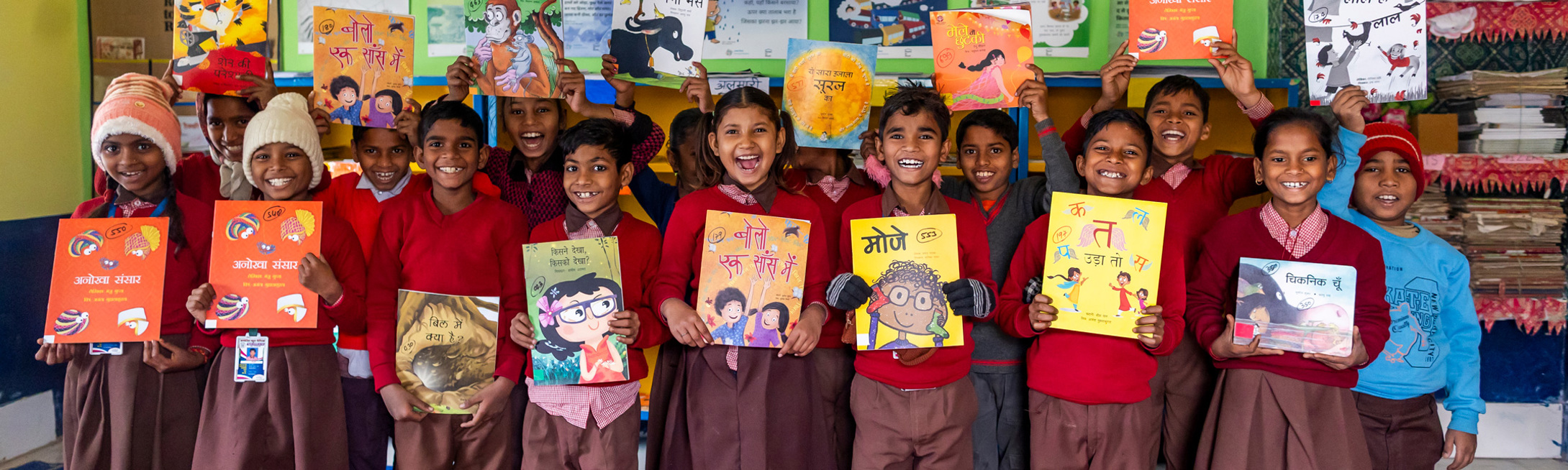 Indian Students holding Room to Read books in library