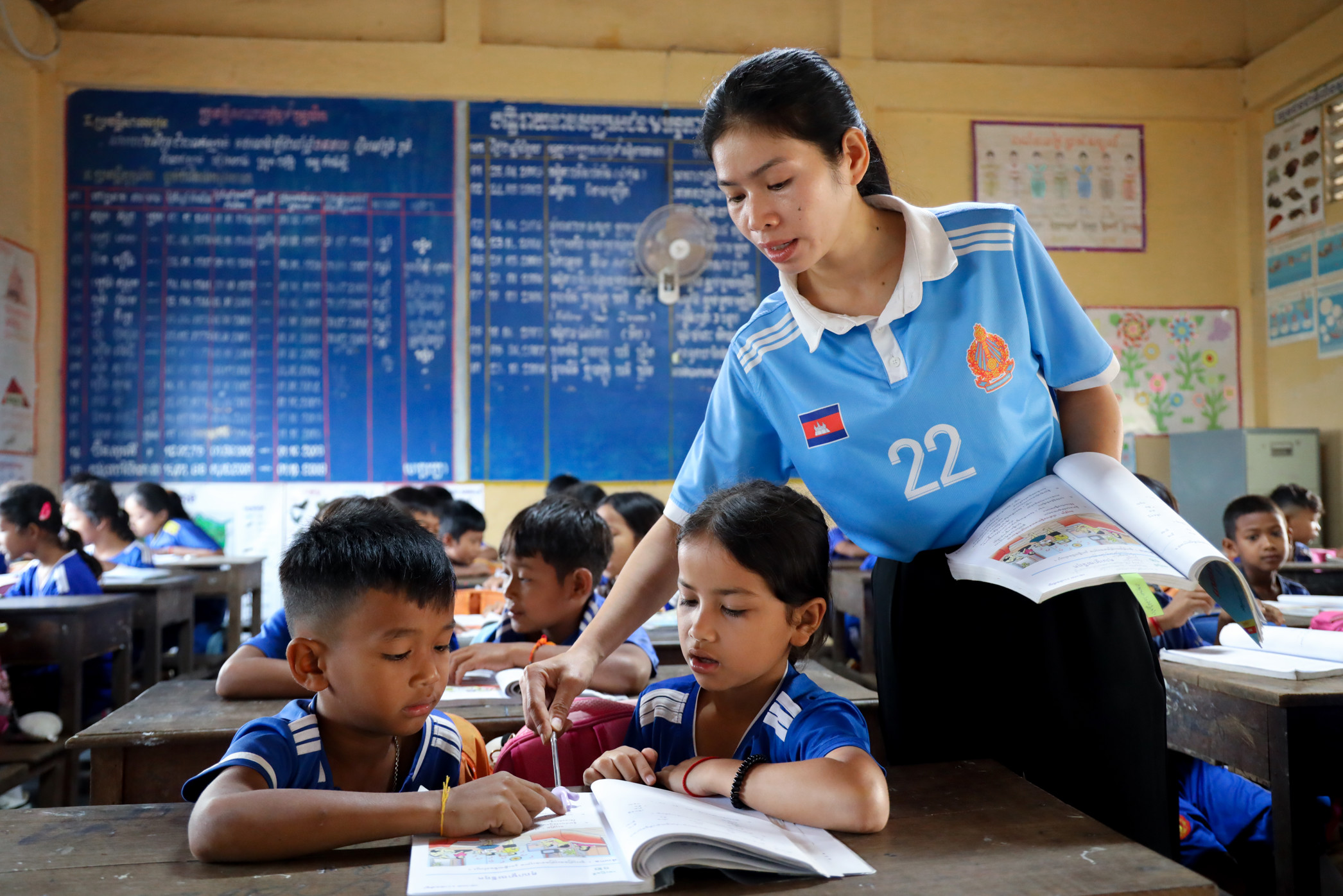 Equity in education, a teacher and student working together in a Room to Read classroom