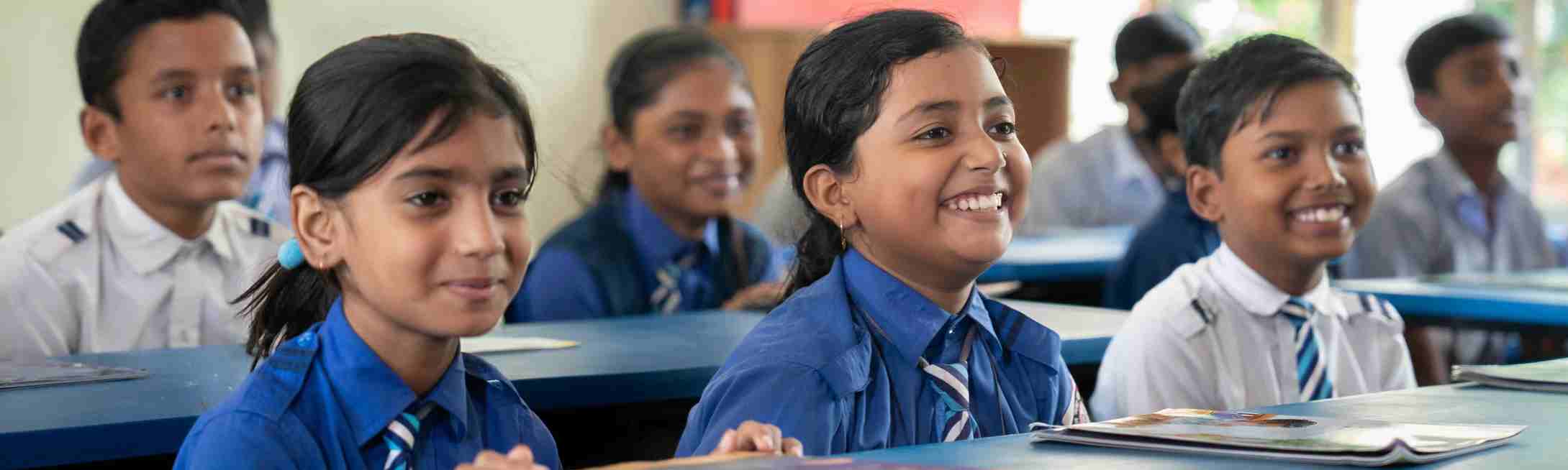 Education nonprofits children seated at desks in Room to Read-supported classroom in Bangladesh