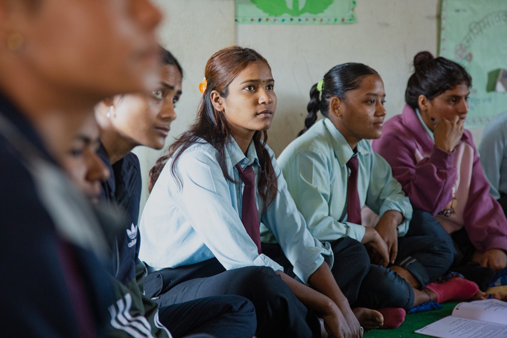 How to support girls' education, girls listening intently in a Room to Read classroom